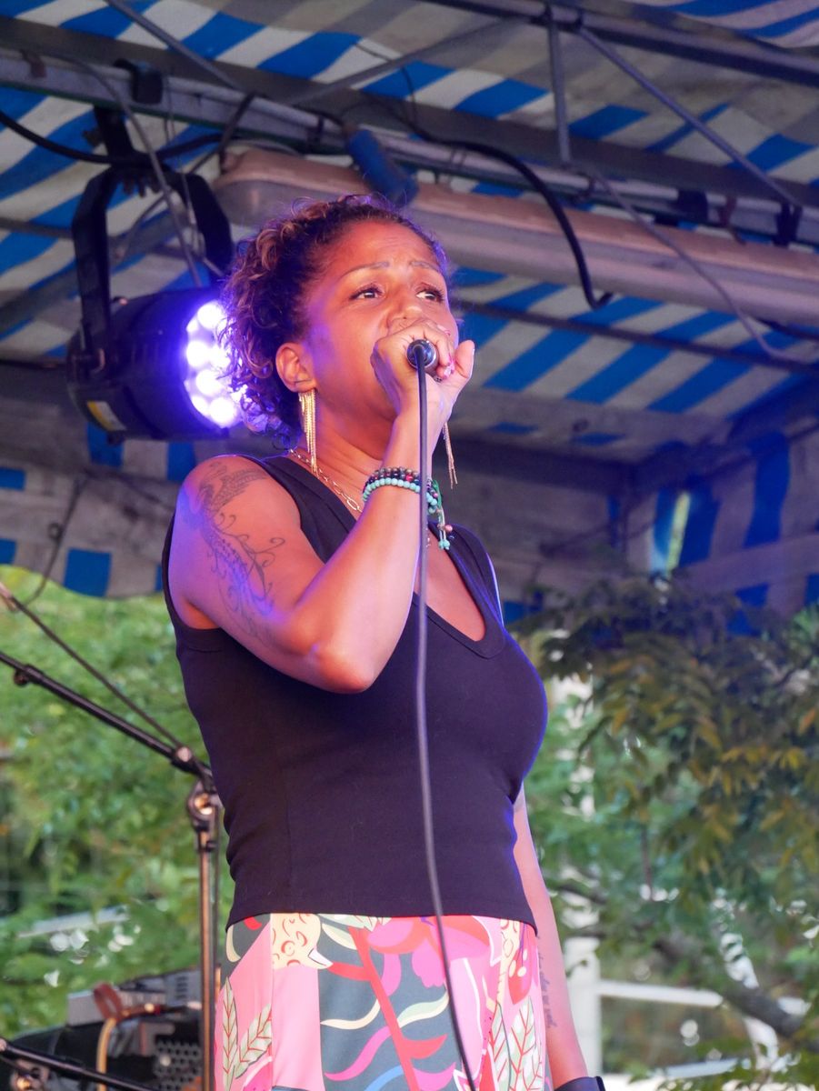 Esther au micro sous le chapiteau, lumières bleues